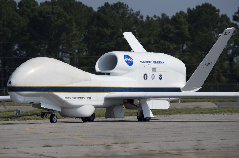 A NASA Global Hawk unmanned aerial vehicle, or drone aircraft, is towed after landing during a Hurricane and Severe Storm Sentinel, or HS3, mission at NASA's Wallops Flight Facility in Wallops Island, Virginia, on September 10, 2013. The HS3 mission uses two of the unmanned aircraft to fly over tropical storms and hurricanes to monitor weather conditions, utlilizing the  Global Hawk's ability to fly as high as 19.8 km (12.3 miles), as far as 20,278 km (12,600 miles) and stay in the air for as long as 28 hours. AFP PHOTO / Saul LOEB
